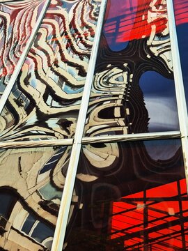 Reflections of a modern building on glass windows