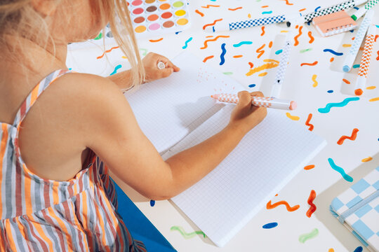 Toddler girl drawing with colors