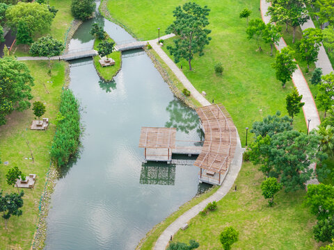 Aerial View of Green Park with River and Wooden Pavilions