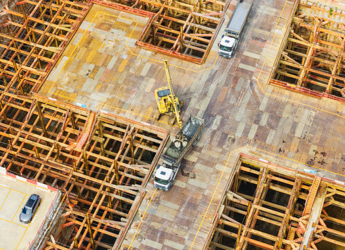 Aerial View of Excavator Loading Truck at Site