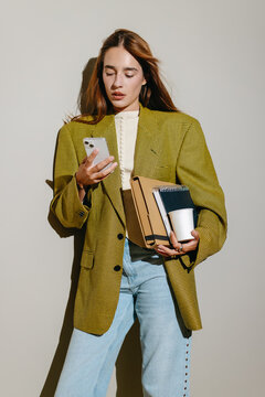 Stylish Young Woman Holding Phone and Clipboard