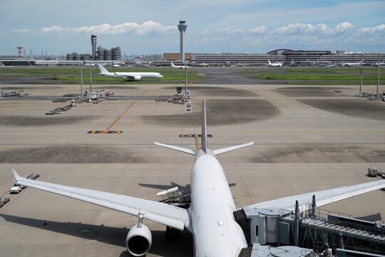 Passenger Aircraft at Airport Terminal and Control Tower