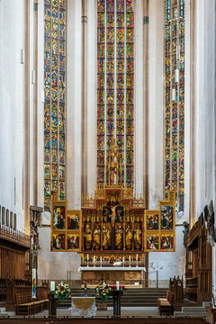 Rothenburg ob der Tauber, Germany &ndash; May 24, 2025: The Altar of the Twelve Apostles inside St. James&rsquo;s Church, featuring gilded carvings, Gothic paintings and stained-glass windows created  1350-1400.