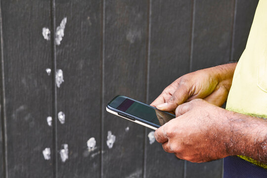NBN Technician Working on a Site Using iPhone