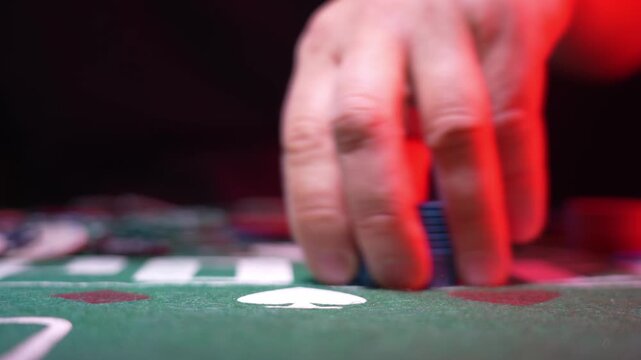 Close-up of green felt casino table with poker chips and playing cards