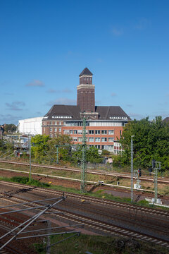 Berlin, Germany; 1st October 2026: Industrial cityscape featuring a historic brick tower overlooking railway tracks in Berlin Moabit Distict.