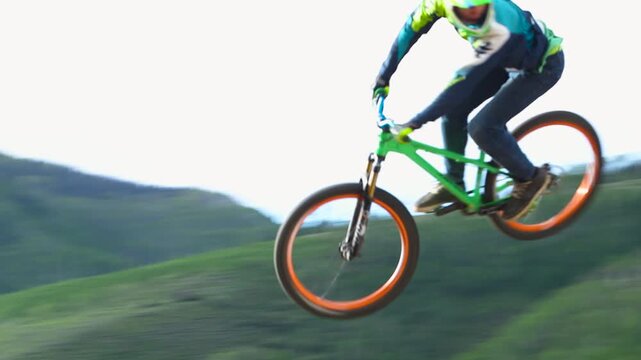 BMX Athlete doing 360 spins off of dirt jumps
