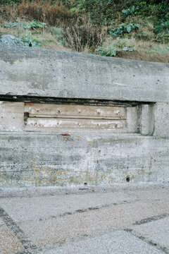 Concrete bunker fortification remnant along the hillside during the daytime in daylight