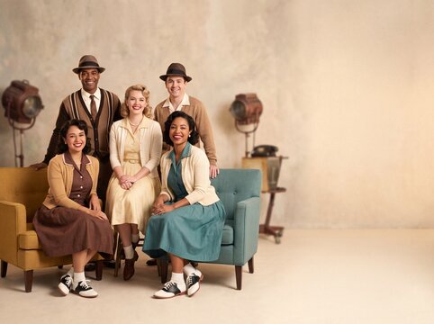 Group of friends pose together on vintage couches