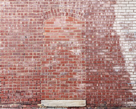 old brick wall with bricked up doorway background texture 