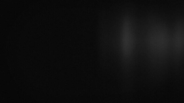 Black and White Grainy Light Texture Animation, Seamless Loop. Looping monochrome animation of gray light moving across a black background. Subtle noise, diffused highlights, and blurred gradients 