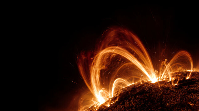 Vibrant solar plasma arcs glowing in orange and yellow on a deep