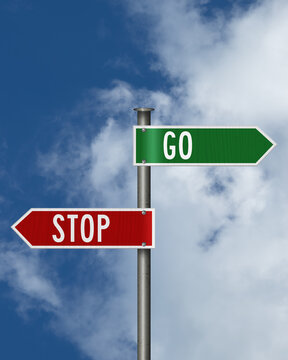 Green Go and red Stop sign with sky