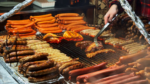 Grilling Traditional German Sausages and Bratwurst on BBQ Street Food Market