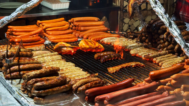 Grilling Traditional German Sausages and Bratwurst on BBQ Street Food Market