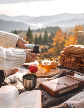 Cozy Autumn Picnic Banner with Hot Tea Thermos and Scenic Mountain View.