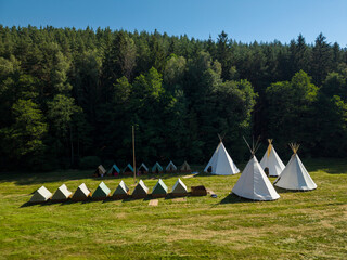 Traditional teepees and tents camping in forest Manetin Czechia © Richard Semik