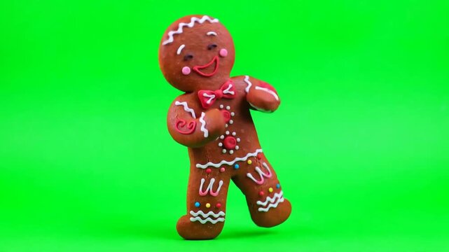Cute gingerbread man cookie dancing on green screen background