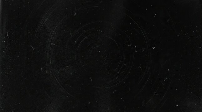 Abstract dark grunge texture with circular scratches and dust particles