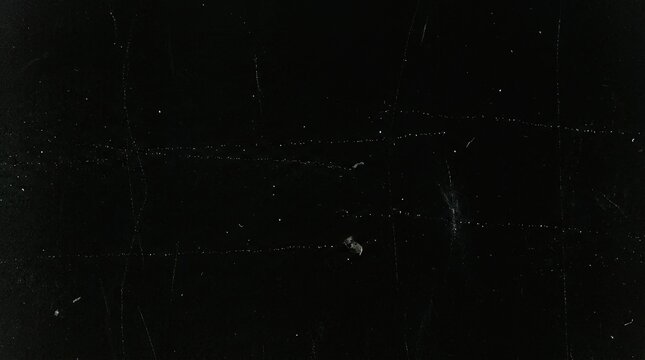 Old film texture with scratches and dust particles on black background