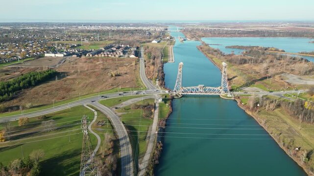Aerial over the Welland Canal, St. Lawrence Seaway in St. Catharines, Ontario, Canada. Glendale Avenue Lift Bridge towards lock 3, Niagara-on-the-Lake and Lake Ontario. November 2024. Part 2 of 2.