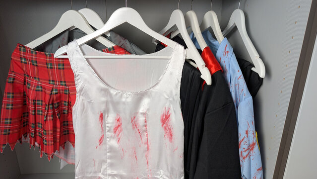 Bloody Halloween costume dress hanging in a closet. 