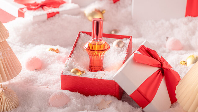 Potent perfume glass placed alongside cheerful holiday decor.