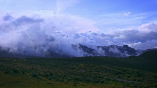 Los Nevados National Natural Park Colombia, Parque de Los Nevados, high Andean paramo landscape with drifting clouds and fog over mountain ridge, blue sky, Cordillera Central, Andes, 4K video
