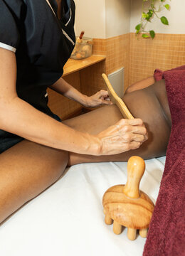 Woman receiving maderotherapy on leg at spa