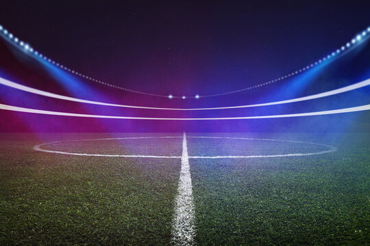 Football soccer stadium in neon fog light. Green grass.