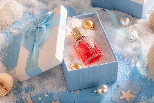 Lovely fragrance flacon placed in elegant Christmas glass.