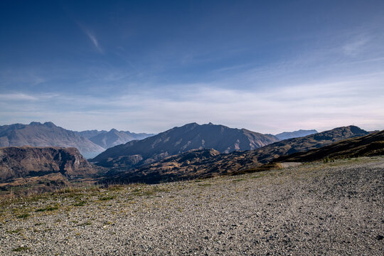 Road background, automotive backplate, gravel road in high mountain environment with spectacular views