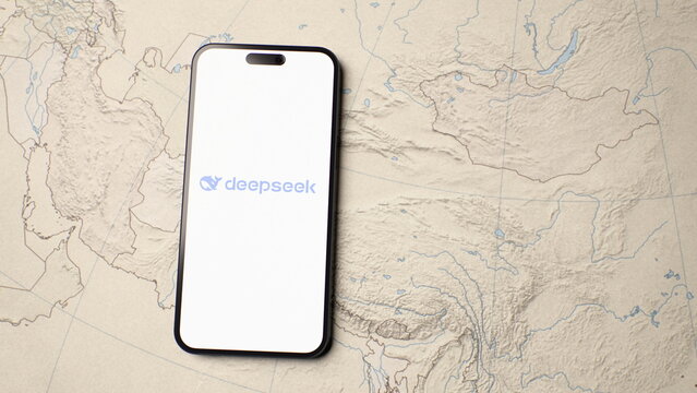 Top view of the DeepSeek logo displayed on a smartphone lying on a printed map highlighting China. October 4, 2026, Lisbon, Portugal.