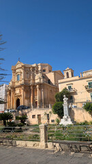 Ornate Baroque Church and Fountain in a Sicilian Town Square © Mangirdas