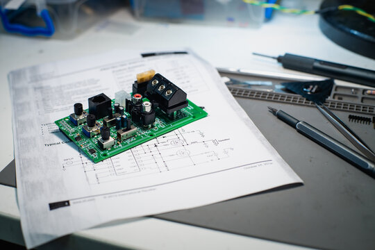 Audio Circuit Board on Printed Electronic Schematic on Repair Mat

