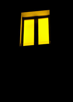 window with a yellow light on a black background. Book cover, graphic, illustration, poster