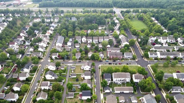 Detached houses and townhouses line intersecting streets in this Leesburg Virginia aerial view.