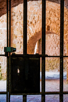 Ibiza, Balearic Islands: gate lock, bars, tone arch and underground tunnel in Dalt Vila, historic walled old town of Ibiza, serving as secret passage through 16th-century Renaissance fortifications