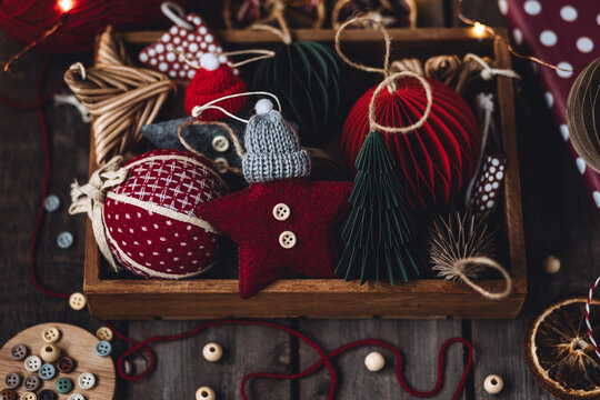 Family time, leisure activity, hobby, holiday recreation with children. Process of creation of handmade Christmas toys with cloth, buttons, honeycomb craft recycled paper. Zero waste, diy gift