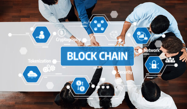 A diverse group of professionals collaborates on blockchain technology in a modern workspace, exploring concepts like cryptography, security, and tokenization strategies. Amity