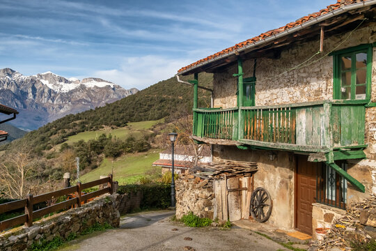 Rural village of Tudes overlooking snow-capped Picos de Europa, Cantabria, Spain