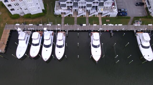 Moored boats and empty slips alternate beside the residential marina waterfront near Manteo.