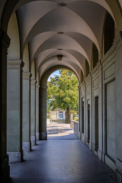 Historic covered sandstone arcade walkway in Altstadt Old Town Bern, Switzerland