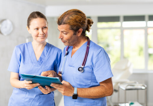 Doctors or surgers with paper board or patient folder (OPD) with serious thinking.
