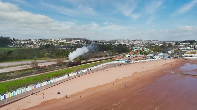 Steam Train over Goodrington Beach from a drone, Paignton, Devon, England, United Kingdom