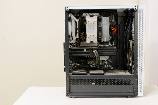 Desktop computer internal hardware covered in thick dust inside the case