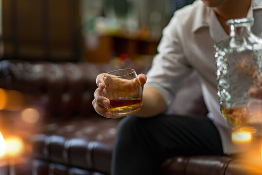 Closeup businessmen holding a glass of whiskey
