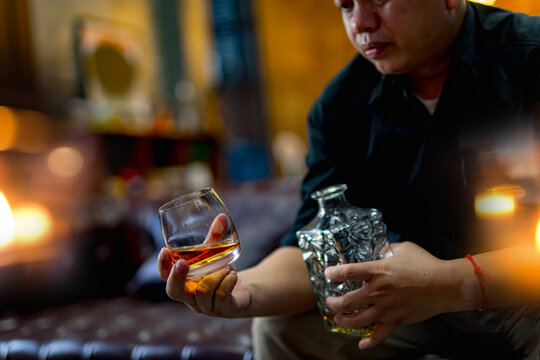 Closeup businessmen holding a glass of whiskey