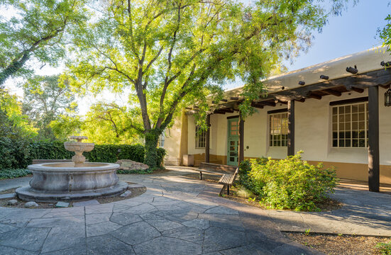 Spanish Colonial Style Building with Stone Fountain and Patio