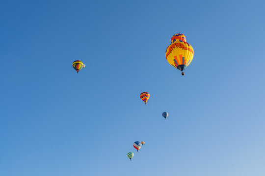 Colorful Hot Air Balloons Floating in Clear Blue Sky